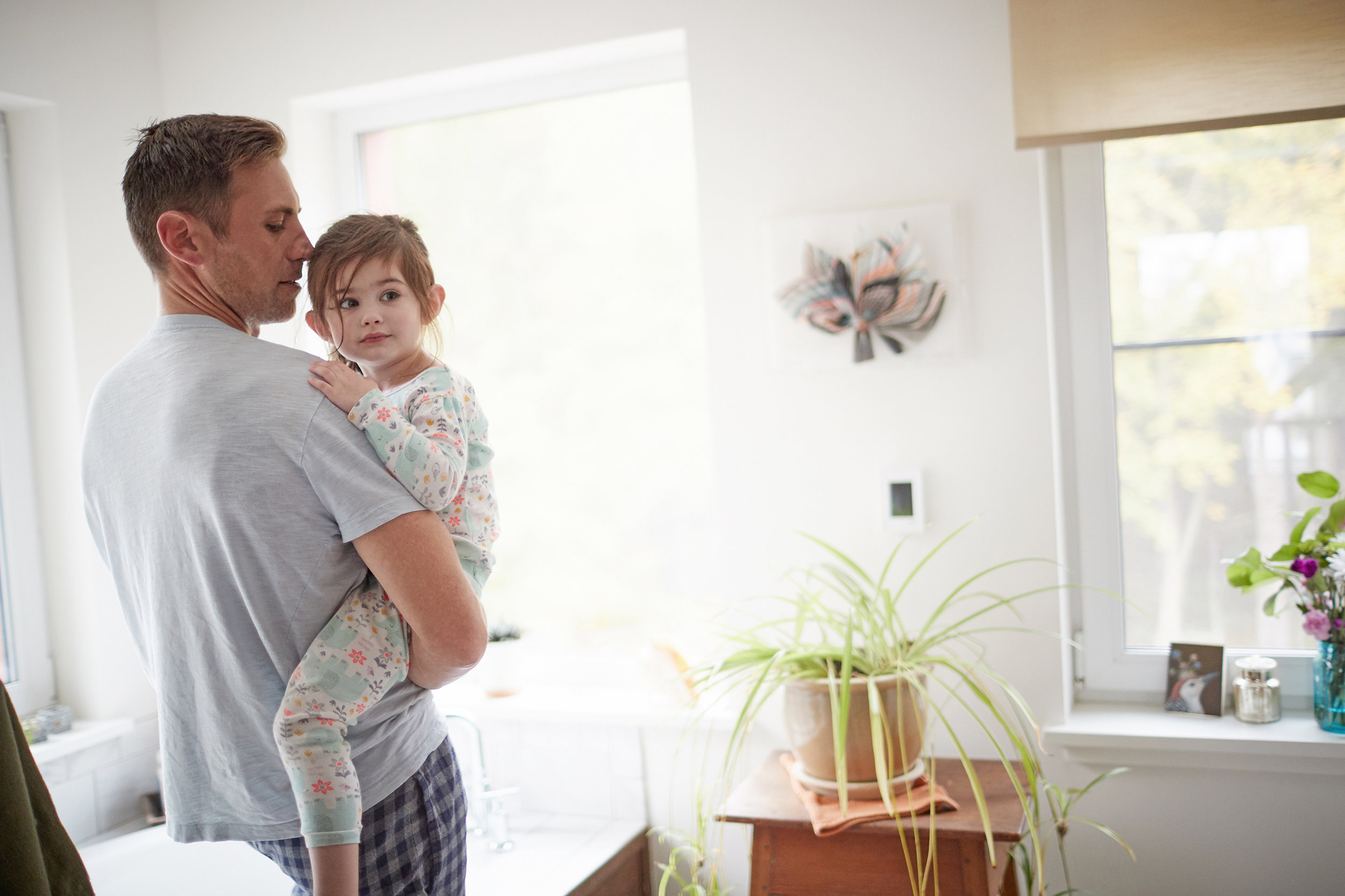 Father caring for his young daughter in their house professional advertising photographer
