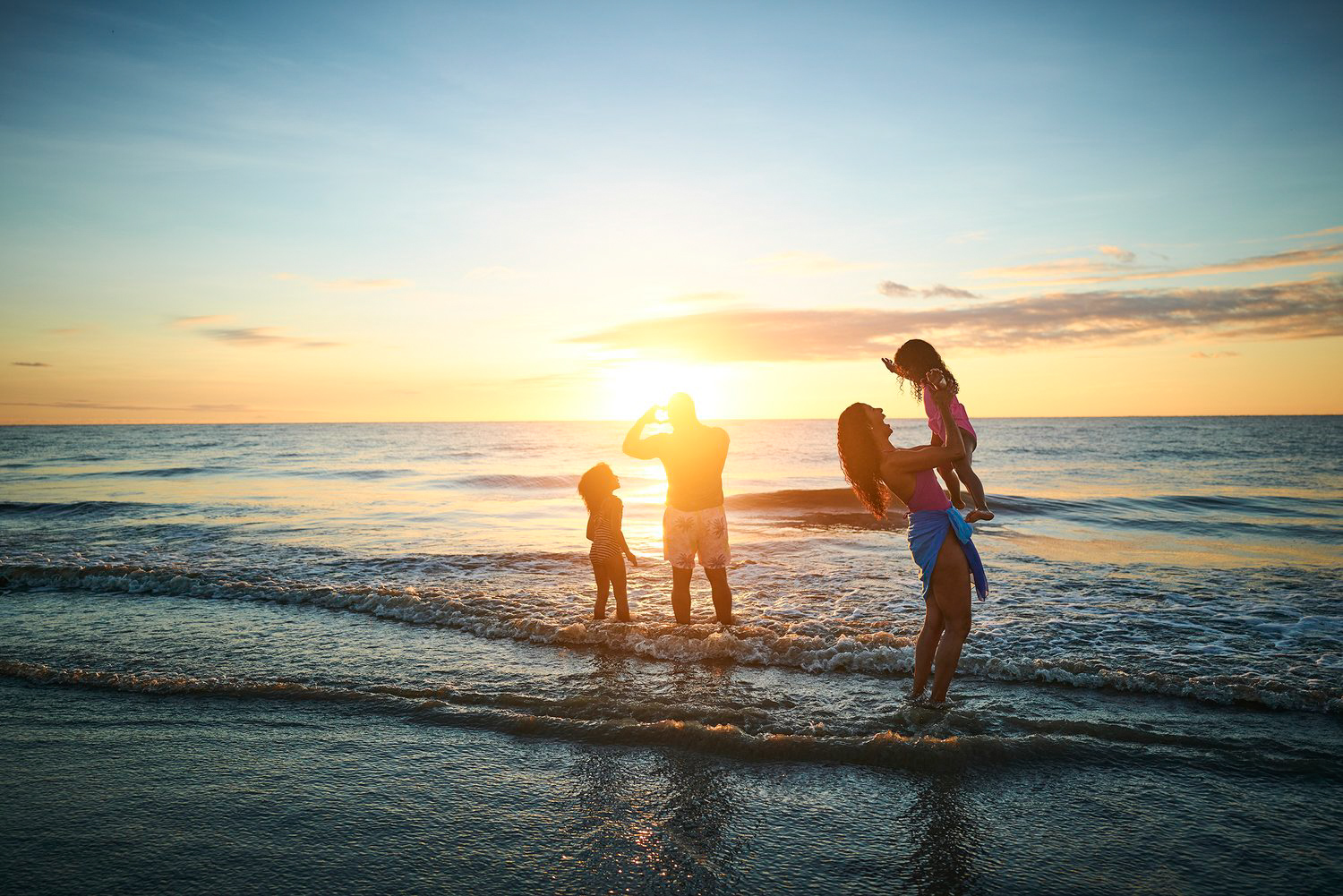 young black family playing on the beach together on vacation professional tourism advertising campaign for Golden Isles Georgia tourism photography and video